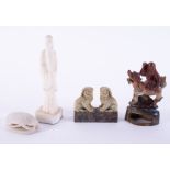 A pair of soapstone carved Chinese foo dogs, another carved dragon back figure and two others, (