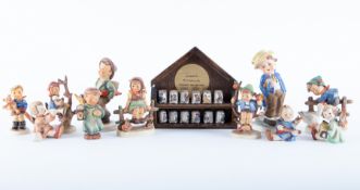 A collection of nine Hummel figures including 'Just Resting' together with twelve Authentic Hummel