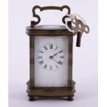 A small carriage clock with key, height including handle 15cm.