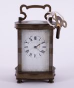 A small carriage clock with key, height including handle 15cm.