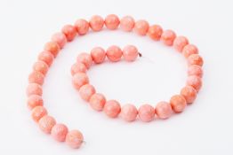 An unstrung string of 38 coral beads, 14mm, approx. 150gm.