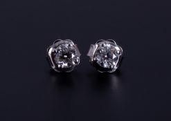 A pair of 18ct white gold studs set with approx. 0.74 carats of round brilliant cut diamonds (0.37