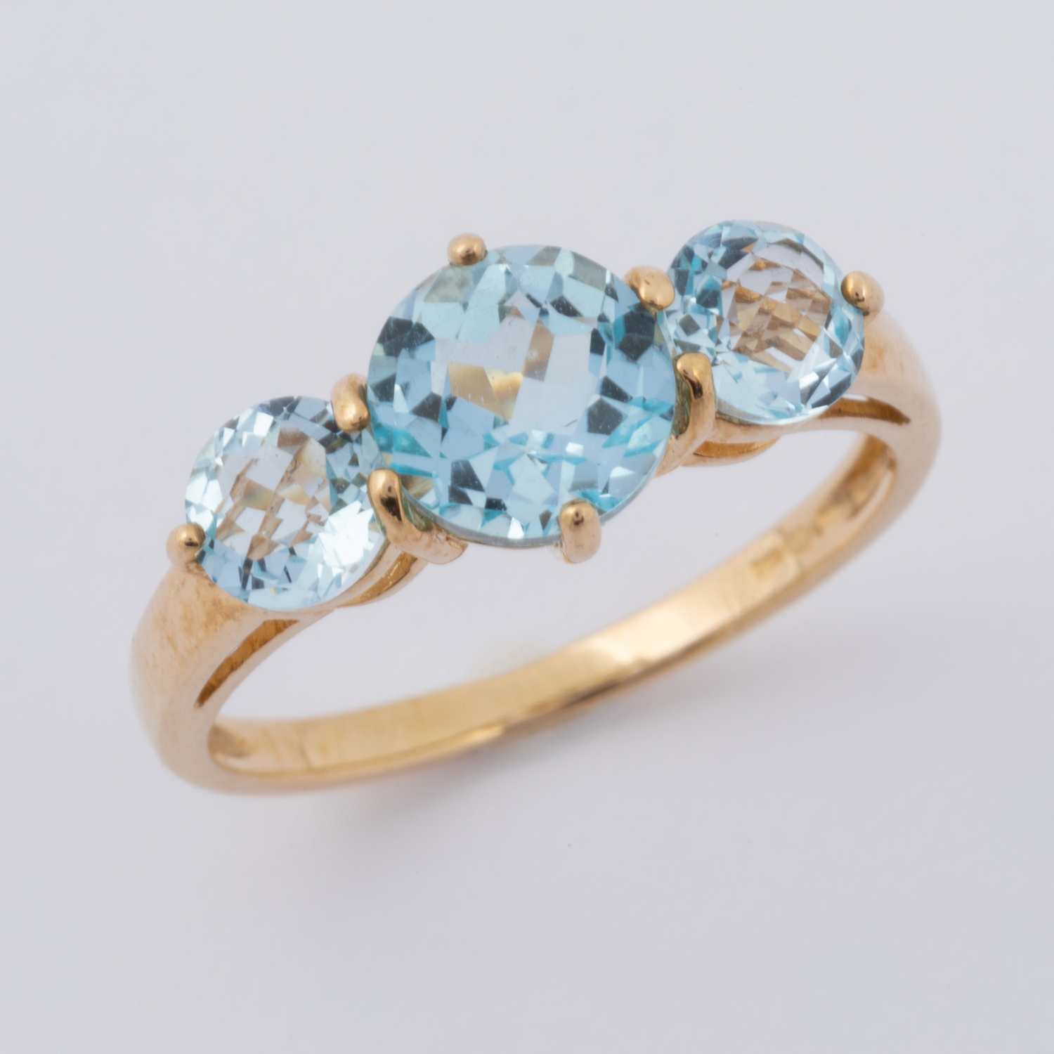 A 9ct yellow gold ring set with three round cut blue topaz, total weight of topaz approx. 2.30