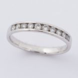 A 9ct white gold half eternity style band set with approx. 0.30 carats of round brilliant cut