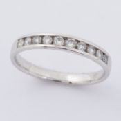 A 9ct white gold half eternity style band set with approx. 0.30 carats of round brilliant cut