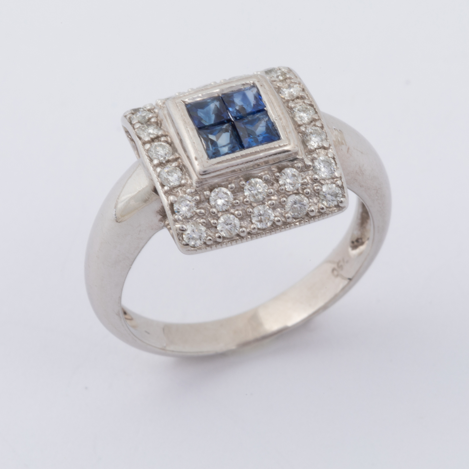 An 18ct white gold square designed ring set centrally with four square cut sapphires, total weight