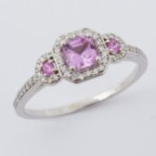 An 18ct white gold ring set with a central step cut square pink sapphire, approx. 0.75 carats,