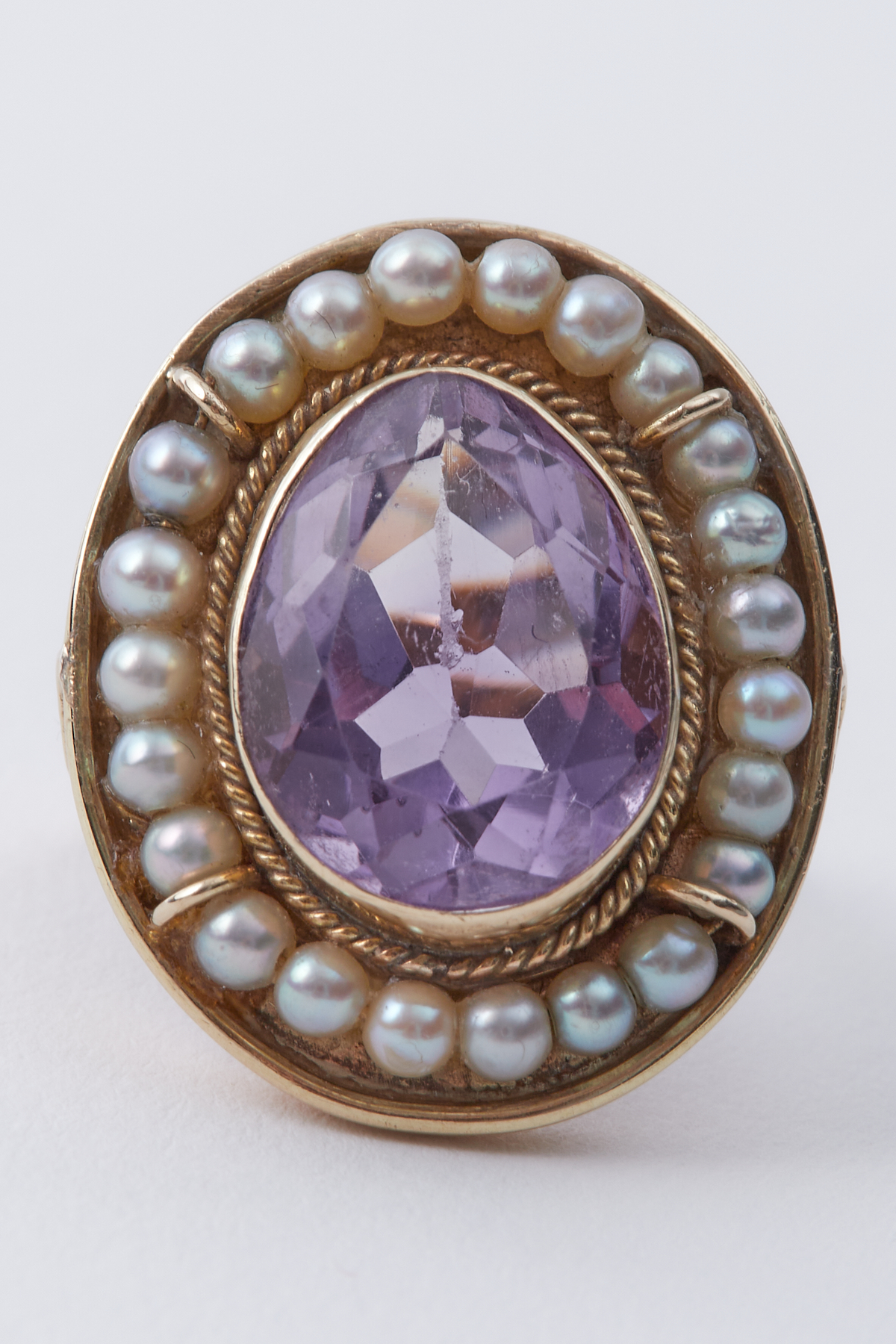 A 14k yellow gold ring set with a central pear shaped amethyst, approx. 7.14 carats, surrounded by - Image 2 of 2