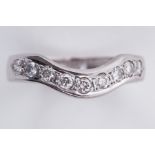 An 18ct white gold heavy guage wishbone style ring set with nine round brilliant cut