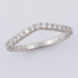 An 18ct white gold shaped half eternity style ring set with approx. 0.57 carats of round brilliant