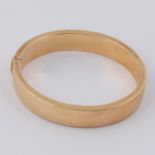 A 9ct yellow gold hinged bangle with push in clasp, inside diameter 6cm x 5cm, 24.00gm