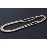 A double strand of Mikimoto cultured pearls, strung to an ornate silver clasp with a central