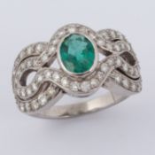 An 'Art Deco' style ring set with central oval cut emerald approx. 1.25 carats (stone measures