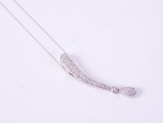 A 14ct white gold elongated design pendant set with approx. 0.65 carats of round brilliant cut