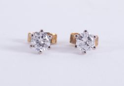 A pair of 18ct yellow & white gold studs set with round brilliant cut diamonds, total diamond weight