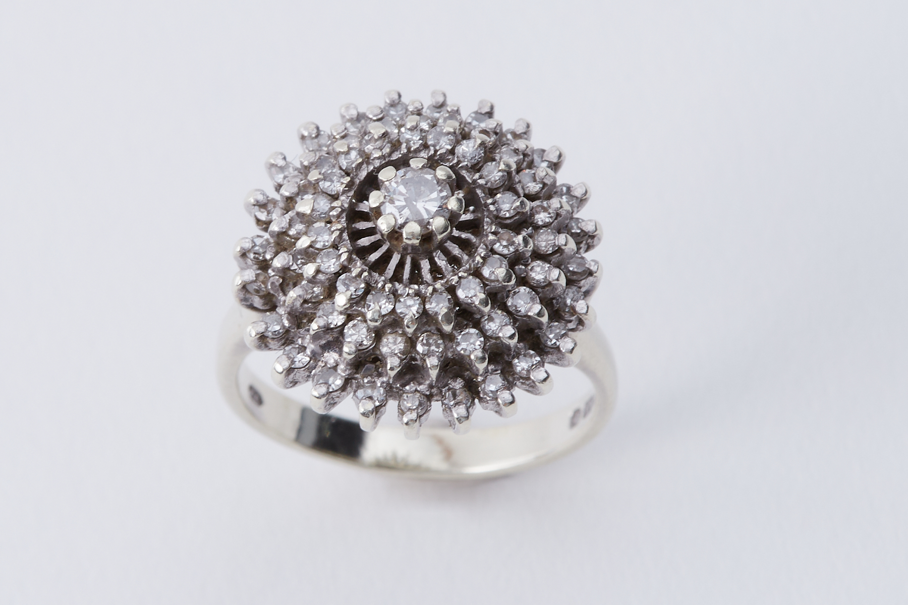 A 9ct white gold cluster style cocktail ring set with round brilliant cut diamonds, approx. 0.36