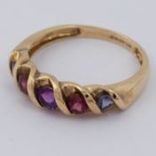 A 9ct yellow gold ring set with multi-colour round cut gemstones to include amethyst & garnet, 1.