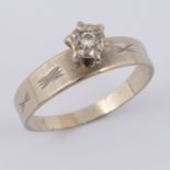 An 18ct white gold ring set with an older round cut diamond in an illusion setting, approx. 0.03