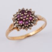 A 9ct yellow & white gold flower cluster design ring set with round cut rubies and diamonds, 1.79gm,