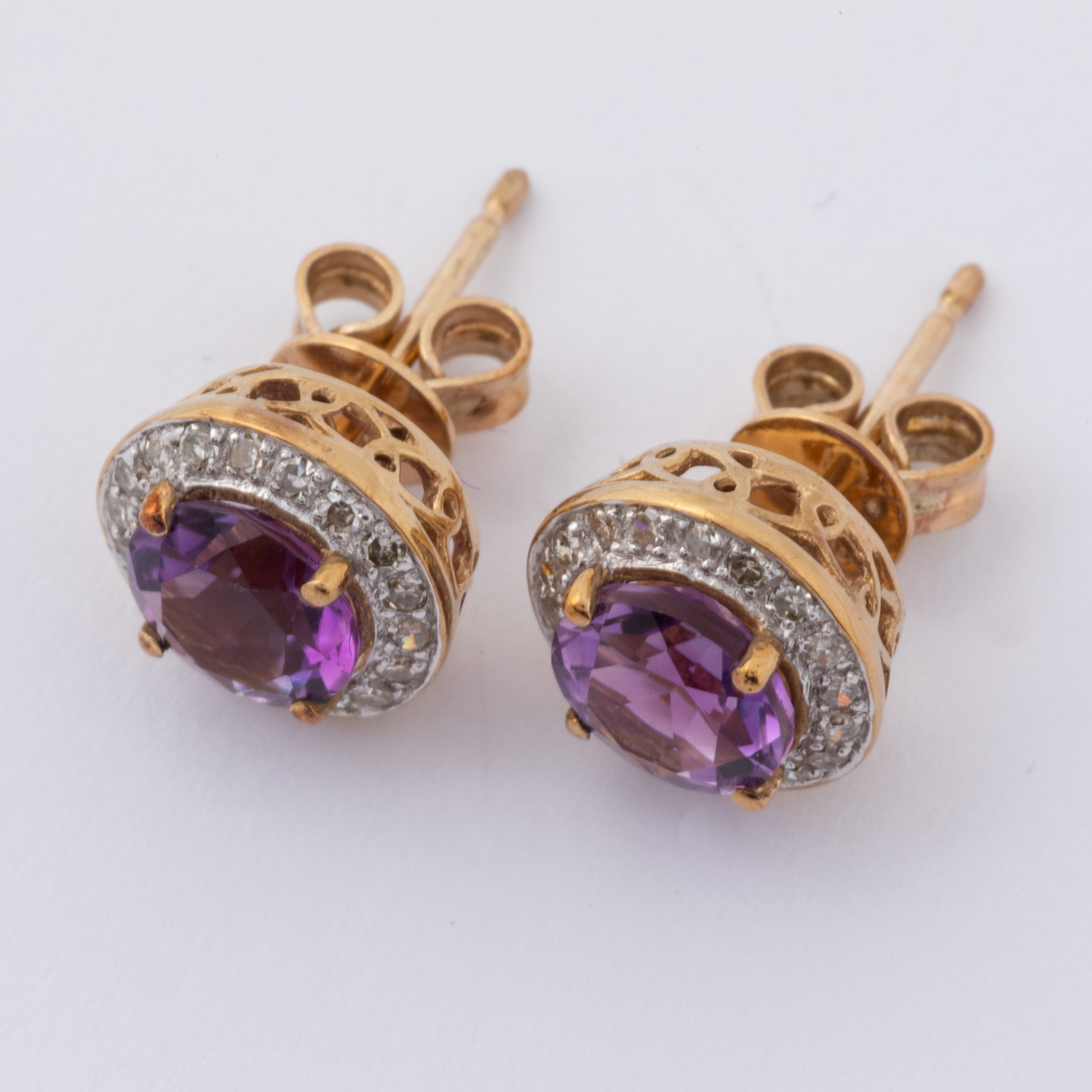 A pair of 9ct yellow gold stud earrings set with a round cut amethyst and surrounded by small - Image 2 of 2