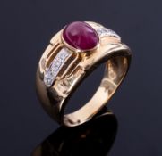 A wide band style ring set with a central cabochon cut ruby measuring 8.50mm x 6.50mm, approx. 2.