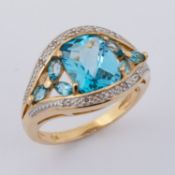 A 9ct yellow gold ring set with a central fancy rectangular cut blue topaz & marquise cut blue topaz