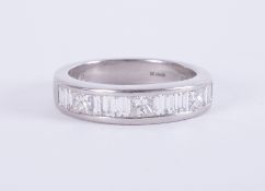 A platinum half eternity style ring set with a mixture of baguette cut & princess cut diamonds,