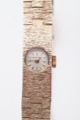 Bueche-Girod, a ladies 9ct yellow gold textured brick link wristwatch, approx 27.50g, cased.