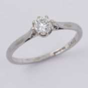 A platinum eight claw solitaire ring set with approx. 0.30 carats of older round cut diamond, colour