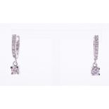 A pair of 18ct white gold drop earrings set with round brilliant cut diamonds, there is a diamond