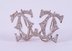 A pair of 18ct white & yellow gold earrings inspired by the Cartier double 'CC' design, set with