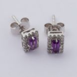 A pair of 14ct white gold rectangular cluster style earrings set with a central amethyst and