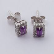A pair of 14ct white gold rectangular cluster style earrings set with a central amethyst and