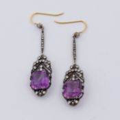 A pair of ornate antique drop earrings set with square cut amethyst coloured stones,