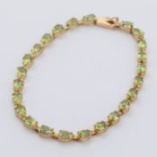A 9ct yellow gold bracelet set with pear shaped peridot, approx. total weight of peridot 7.68