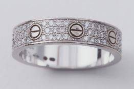 Cartier, an 18ct white gold diamond paved Love wedding band with screw detail set with 88 round