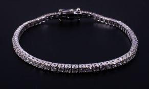 An 18ct white gold line bracelet set with approx. 3.50 carats of round brilliant cut diamonds,