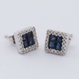 A pair of 18ct white gold square design earrings set centrally with four square cut sapphires, total