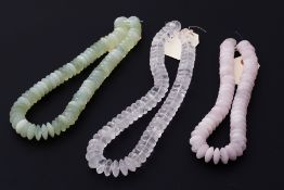 A mixed lot to include a string of rose quartz beads, a string of rock crystal beads and a string of