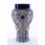 A William Moorcroft Florian ware vase decorated with peacock feathers, circa 1903, height 24cm.