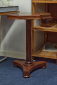 A 19th century octagonal mahogany pedestal wine table together with an oval two tier occasional