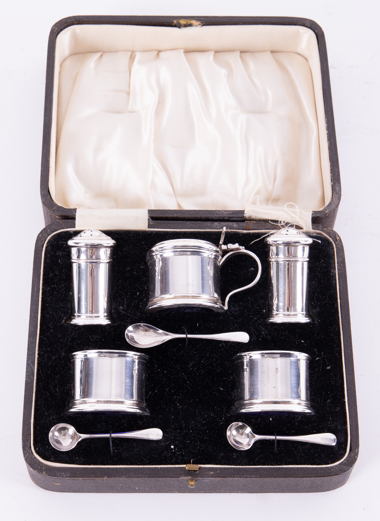 A cased Geo V silver five piece condiment set together with three spoons, including mustard pot