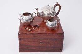 A cased Victorian silver three piece tea service and sugar tongs, circa 1878, approx 20.83oz.