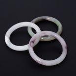 Three 'Jade' bangles, diameter 8cm.