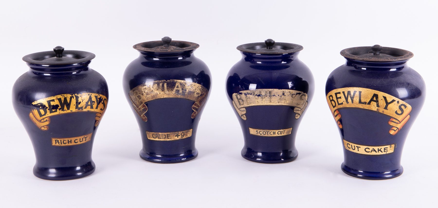 Four Bewlay's shop display tobacco jars with lids, height 22cm.