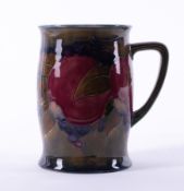 A William Moorcroft tankard decorated with Pomegranate, 12cm height, with stamp.