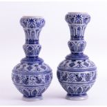 A pair of heavy German stoneware blue & white vases, height 35cm.