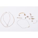 A quantity of 9ct yellow gold items including chain, brooches, charms, broken bangle, etc, 24.65gm