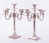 A matched pair of late Victorian silver Corinthian column four branch, five light candelabra, one