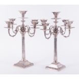 A matched pair of late Victorian silver Corinthian column four branch, five light candelabra, one